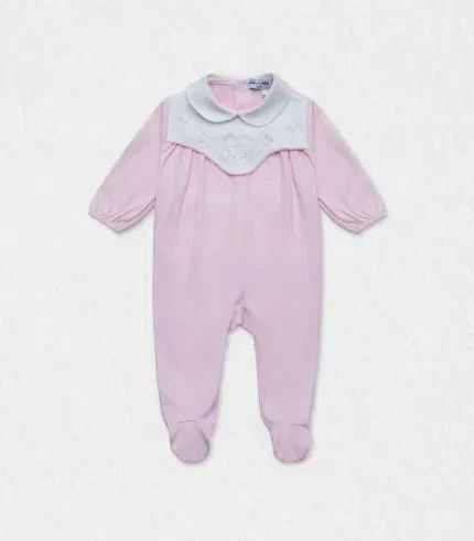 Organic cotton baby pyjama laid flat on blush backdrop in Dubai studio, showing full‑length pink suit with delicate hearts embroidery, nickel‑free snap back, and care tag—premium newborn sleepwear ready for UAE next‑day delivery and worldwide shipping.